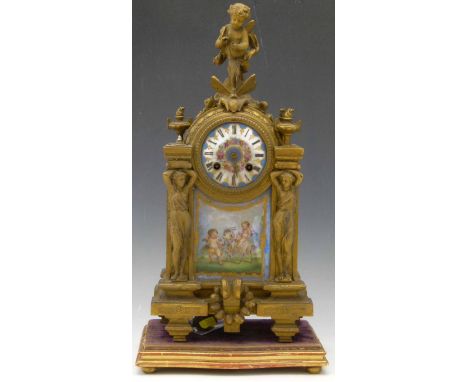 French gilt spelter mantel clock with porcelain panels the case surmounted by a cherub riding a butterfly, eight day movement