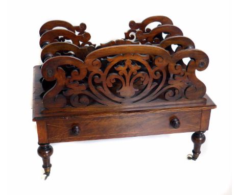 Victorian walnut Canterbury of four fretwork divisions, over a single drawer on turned legs and white ceramic casters, width 
