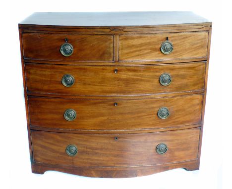Early 19th century mahogany bow front chest of two short and three long drawers, each drawer with cock beading, oak drawer li