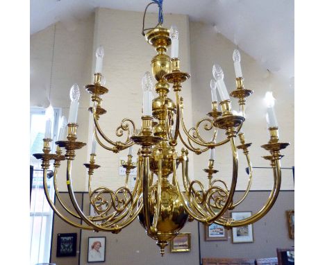 An impressive modern Dutch design brass chandelier, central baluster column with two rows of eighteen scroll shaped arms supp