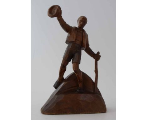 Circle of Otto Moroder (1894-1977),  Male Bavarian figure waving a hat and holding a walking stick, carved wooden sculpture, 