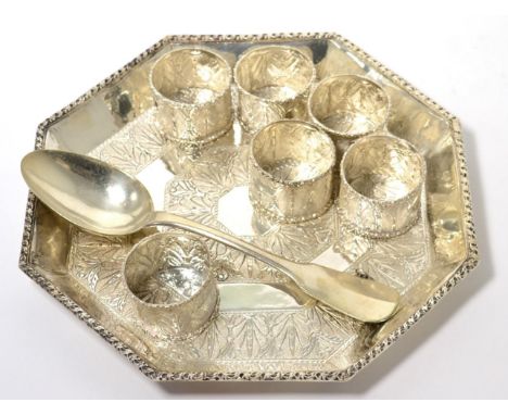 A Persian white metal octagonal shaped tray; six napkin rings; Continental spoon; and a silver and enamel badge 