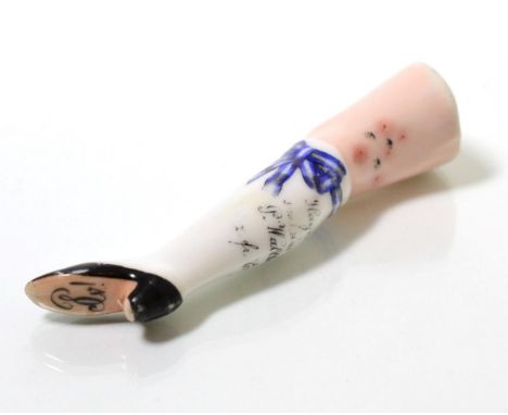 A 19th century Continental china pipe tamper in the form of a lady's leg 