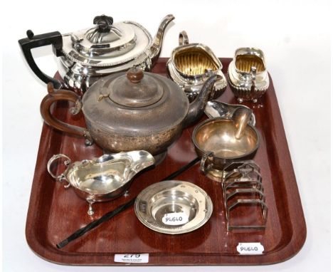 Two silver teapots; a silver cream and sugar; two silver sauce boats; a silver toast rack; modern silver dish; and a silver t