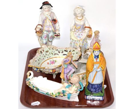 A French porcelain floral painted basket, two Continental figures, a Quimperware model of a Bishop