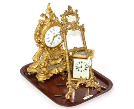 A gilt metal mantle timepiece, a brass carriage timepiece and a brass easel stand  
