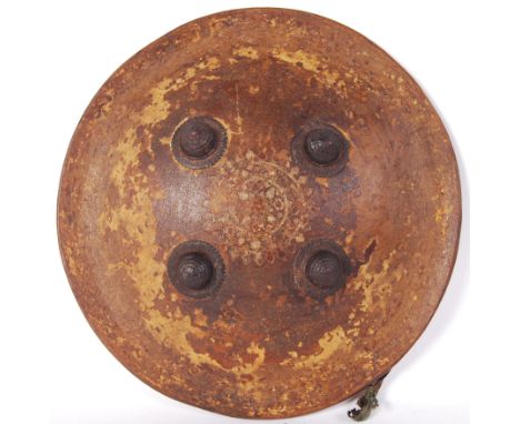 A 19th century Indo-Prussian hide shield or Dhal shield. Iron circular stubs to the exterior panel, and lined cushioned inner