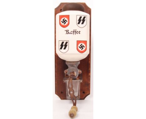 A 20th century Swastika &amp; SS decorated wooden mounted wall 'Kaffee' (Coffee) grinder complete with glass measuring dispen