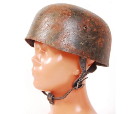 An original Second World War WWII German Nazi Paratroopers helmet. Showing signs of once being netted, the helmet displays th