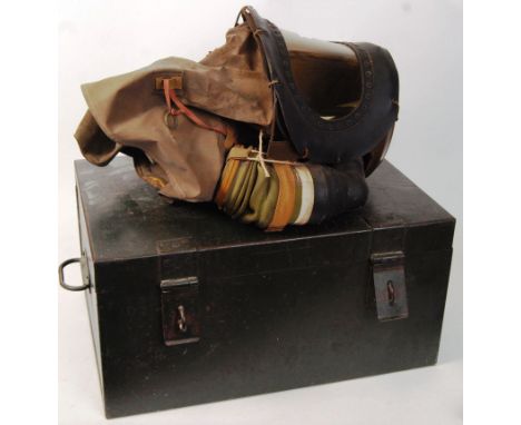 An original WWII Second World War issue babies gas mask unit, within a green military trunk. The trunk measuring; 29cm x 56cm