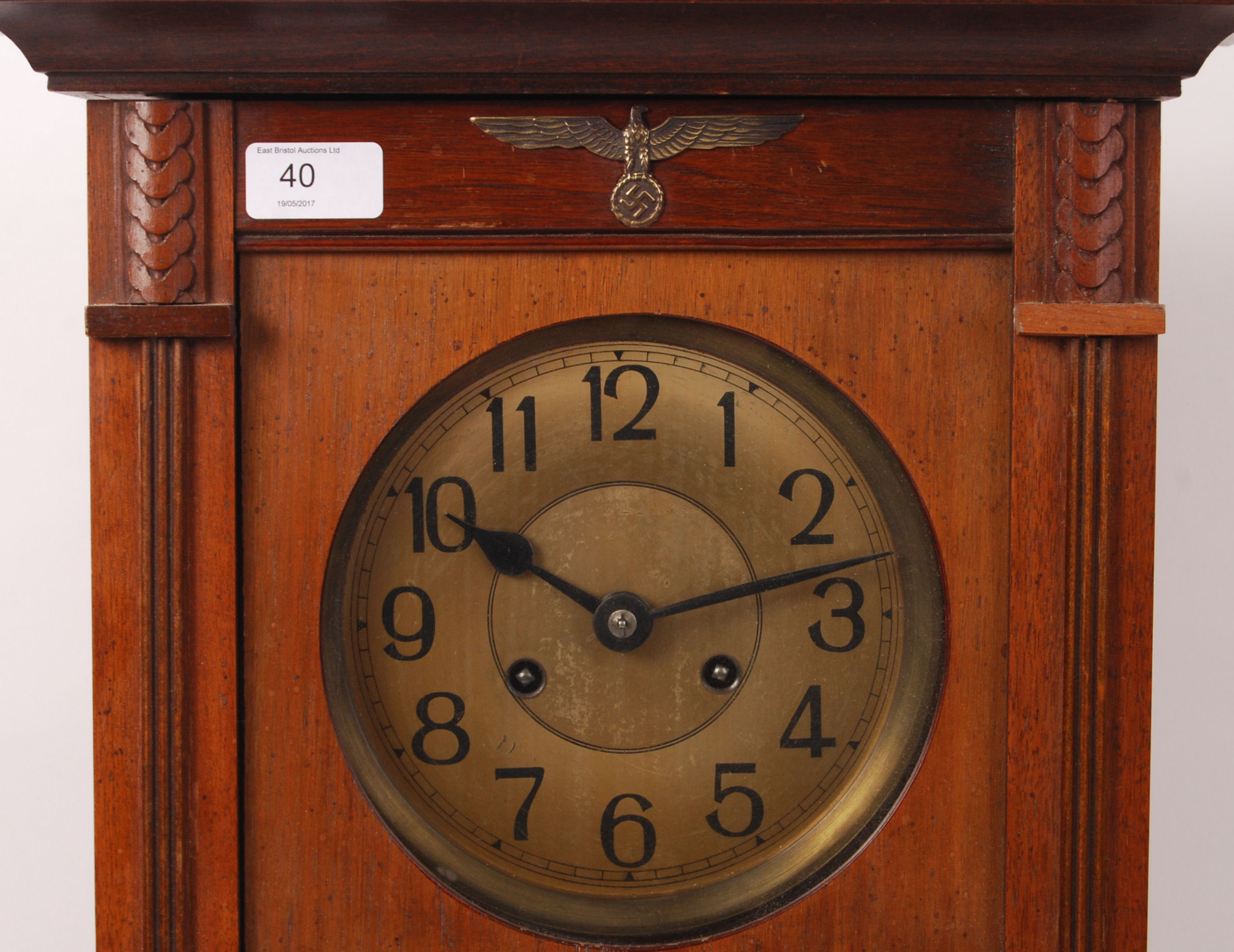 A large 20th century German made wooden wall clock with brass Nazi