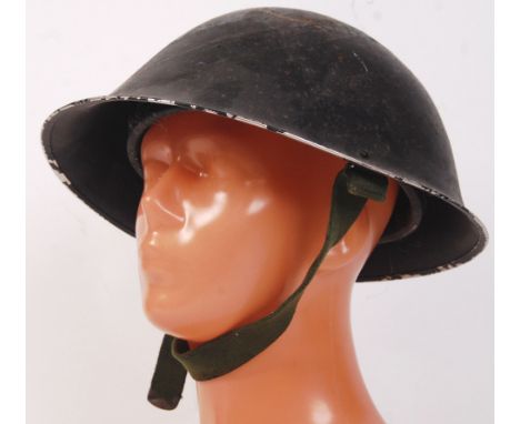 An original WWII Second World War tin 'turtle' military helmet. In black, complete with inner liner and chin strap. 