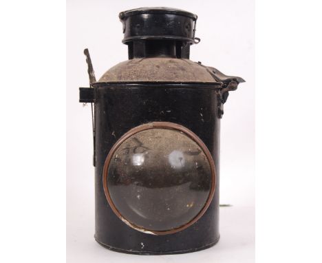 An antique early 20th century electric mountable railway locomotive lamp. With bracket to base, and circular glass lens to fr