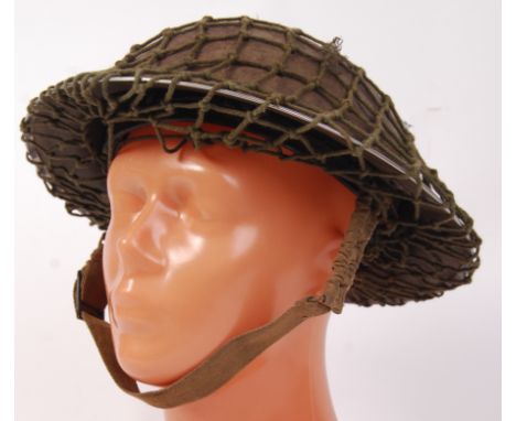 An original Second World War WWII British infantry helmet. With webbing to top, inner liner and chin strap. 