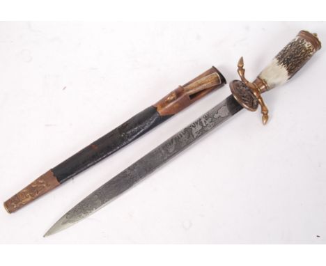 A 20th century German hunting knife. Horn handle, complete with scabbard and smaller horn handled knife. Decorative blade wit