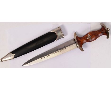 A German Third Reich Nazi SA dagger and scabbard. The etched blade with inscription, wooden handle with inset white metal eag