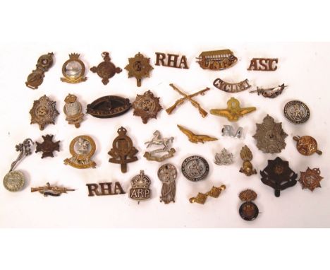 A large collection of assorted original WWI (mostly) and WWII uniform cap (and other) badges. To include; Ypres sweetheart br