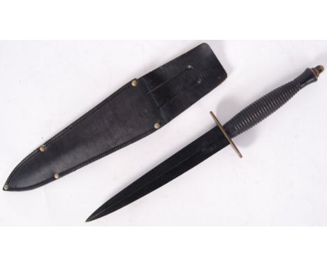 A 20th century Fairbairn Sykes style combat / commando dagger. With turned handle and original scabbard. No markings to blade