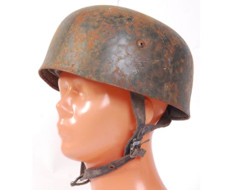 An original Second World War WWII German Nazi Paratroopers helmet. Showing signs of once being netted, the helmet displays th