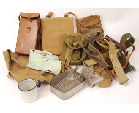 A collection of assorted military webbing and uniform bits. Along with a mess tin, enamel mug, various pouches, bandolier etc