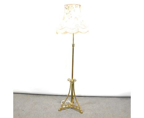 Edwardian brass standard lamp with shade, scrolled base, height 167cm.