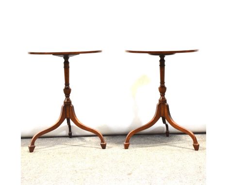 Two mahogany wine tables, one oval, one circular, the tops with crossbanding and stringing, srched tripod legs, height 57cm.Q
