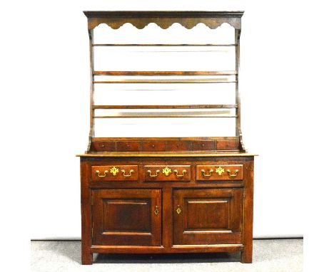 Welsh oak dresser, of small size, open rack above spice drawers, the base with three drawers over two doors, width 131cm, dep