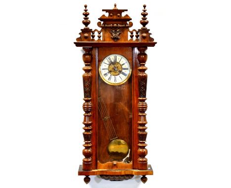 Vienna type wall clock, walnut case, stepped pediment with turned finials, glazed door, circular dial, striking on a gong, 11