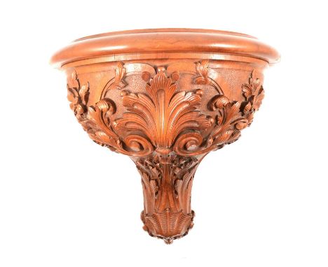 Victorian walnut clock bracket, bowfront platform 26x27cm, carved with scrolls and flowers, overall width 33cm, depth 30cm, h
