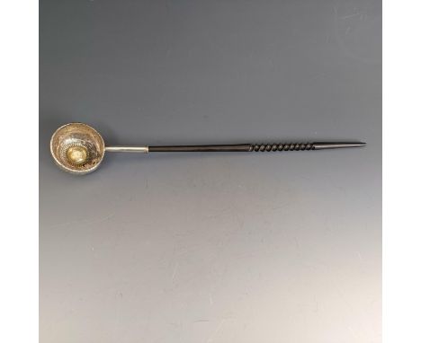 A toddy ladle, the bowl inset with a coin, on a whalebone twist handle, 36.5 cm 