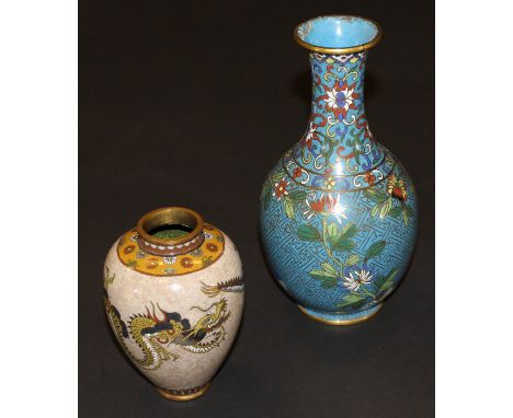 A Chinese cloisonné baluster shaped vase with flared rim decorated with flowers on a  turquoise ground raised on a circular f