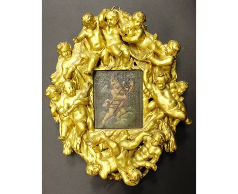 ITALIAN SCHOOL "Cherub on a cloud with ladder", oil on panel, unsigned, housed in a 19th Century Italian carved and gilded fr