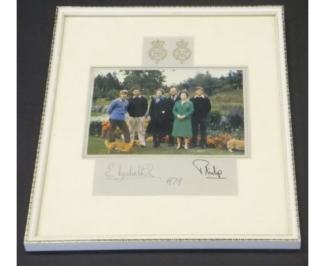 A framed and glazed image of the Royal Family in garden setting with corgis adapted from the 1979 Christmas card signed (prob