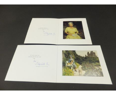 A Christmas card from HRH Elizabeth The Queen Mother depicting the Queen Mother with two corgis in a garden at the Castle of 