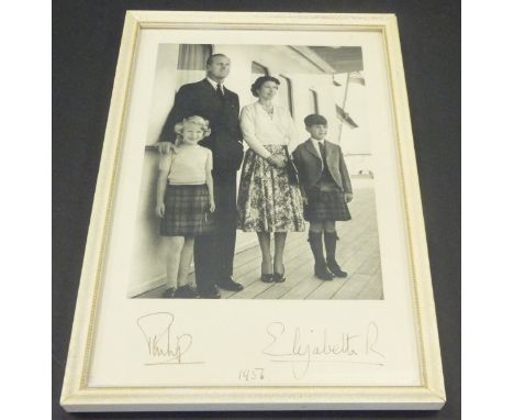 A framed and glazed image of Her Majesty The Queen and Prince Philip with Prince Charles and Princess Anne stood upon the dec