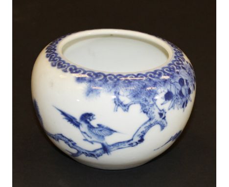 A Chinese porcelain bowl painted in underglaze blue with bird alighting from a branch and with a bat, bearing six character m