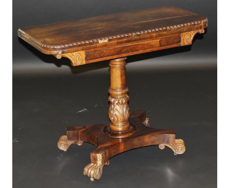 A William IV rosewood card table, the rectangular foldover top with egg and dart rim opening to reveal a baize, on acanthus c