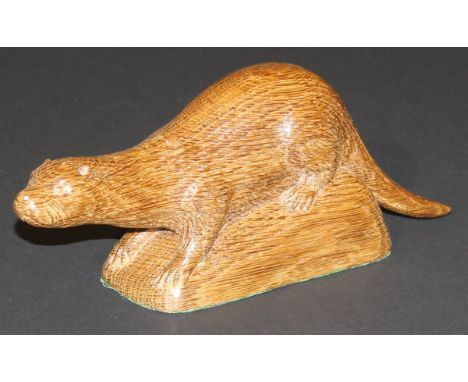 A mid 20th Century Robert Thompson "The Mouseman" of Kilburn carved oak figure of an otter with trademark mouse signature, 27