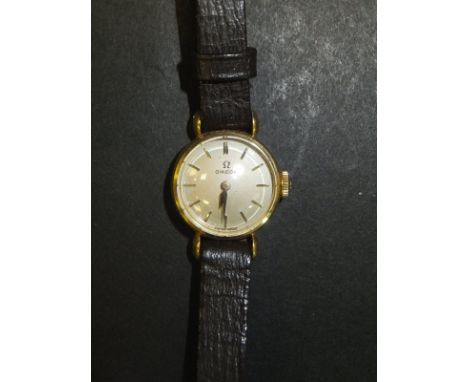 A ladies gold cased Omega wristwatch, the circular dial inscribed "Omega Swiss Made" with brown leather Apollo strap CONDITIO