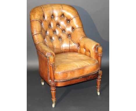 An early 19th Century rosewood show framed brown leather button back armchair on carved and turned legs to Cope's patent bras