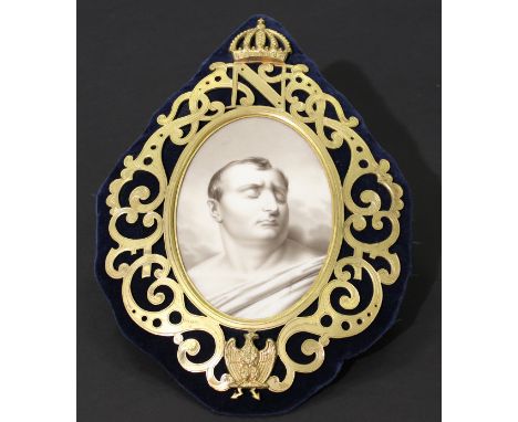 A 19th Century porcelain plaque in the manner of Sevres, depicting Napoleon Bonaparte death mask, housed in a pierced gilt fr