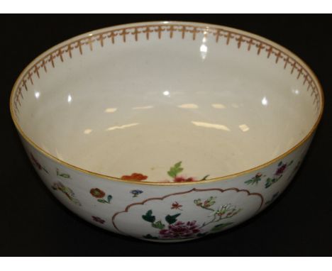 A Chinese porcelain fruit bowl, decorated in the famille-rose palette with floral sprays within cartouches and with flowers a