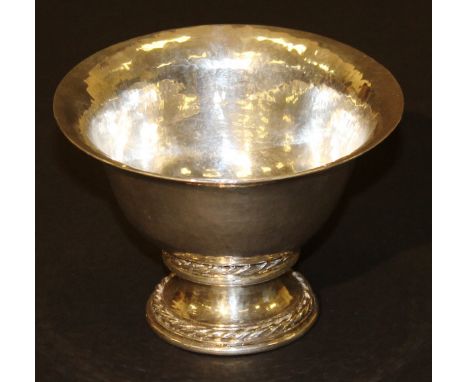 An Omar Ramsden beaten silver pedestal bowl with flared rim raised on a circular stepped base with rope twist decoration, ins