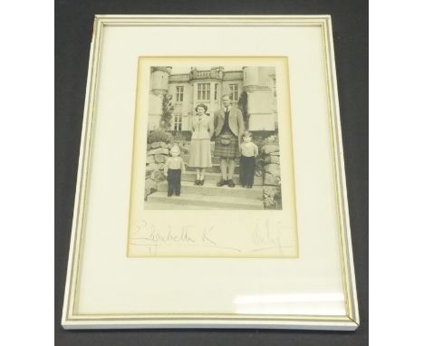 A framed and glazed image of Her Majesty The Queen and Prince Philip at Balmoral with Prince Charles and Princess Anne adapte