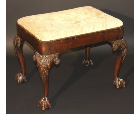 A Victorian walnut framed dressing stool in the early 18th Century manner, the knees carved with acanthus leaves, the cabriol