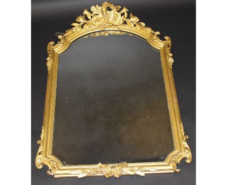 A 19th Century carved giltwood and gesso framed wall mirror with musical instrument decorated surmount, 74 cm x 112.5 cm COND
