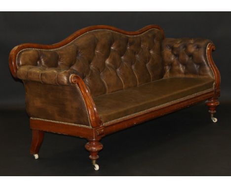 An early Victorian mahogany framed leather button back show frame sofa on turned and ringed front supports to castors, 215 cm