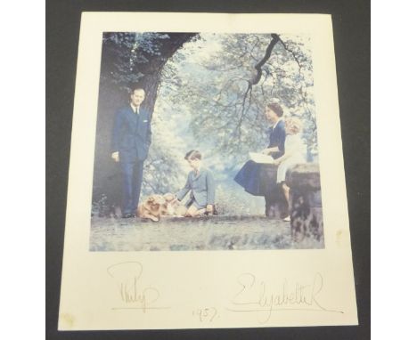 An unframed colour image of Her Majesty The Queen and Prince Philip with Prince Charles,  Princess Anne and two corgis adapte