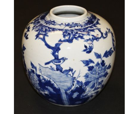 A Chinese porcelain ginger jar painted in underglaze blue with birds amongst blossoming branches and with rocks and chrysanth