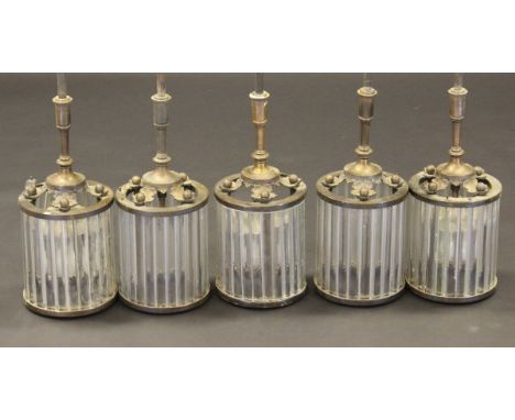 A set of five early to mid 20th Century ceiling lights, each supported on a pendant fitting with cast copper oak leaf decorat